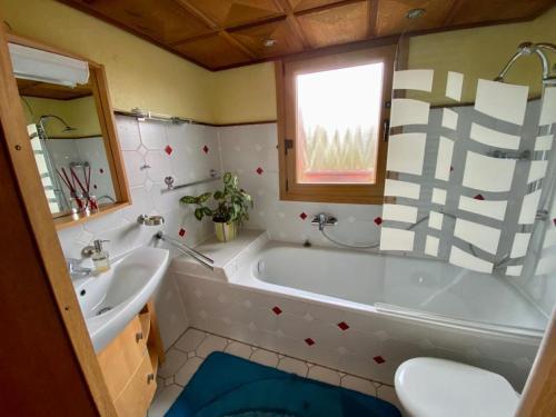 a bathroom with a tub and a sink at Cozy villa with garden, balcony and parking area in Düsseldorf in Düsseldorf