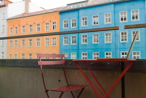 a red chair sitting on a wall next to a building at Seminarhaus S1516 in Berlin