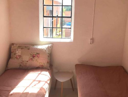 a small room with a bed and a window at Summer House In Rural Surroundings On Bornholm in Svaneke