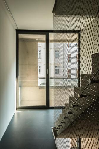 a room with a staircase and a window with a building at Seminarhaus S1516 in Berlin