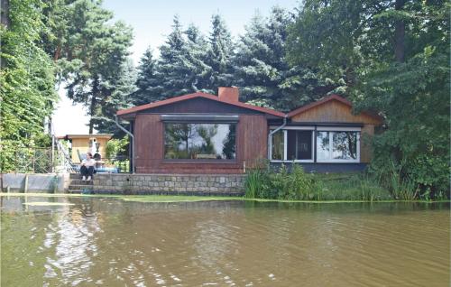a house sitting in the middle of a river at Holiday Home Stromstrasse L in Manschnow