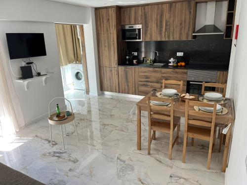 a kitchen with a table and chairs and a dining room at Flat in Olhão city center in Olhão