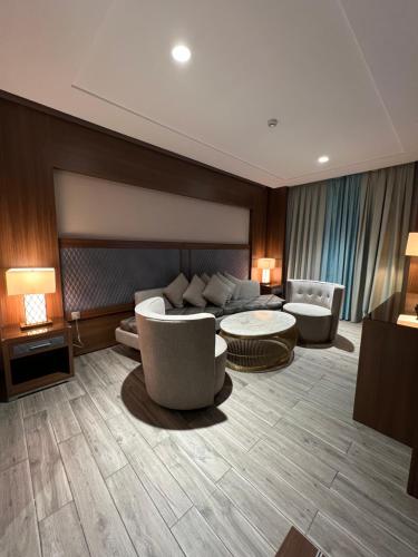 a living room with a couch and chairs and tables at Violet Al Shisha Hotel in Makkah