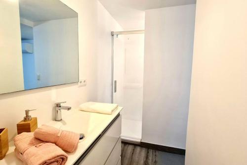 a white bathroom with a sink and a mirror at Barcelona Beach Studio in Barcelona