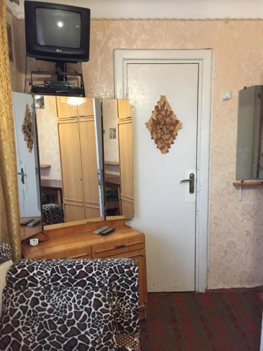 a bedroom with a bed and a mirror and a tv at Квартира 2-кімнатна Бюджетна центр парк-10хв WI-FI in Ternopil