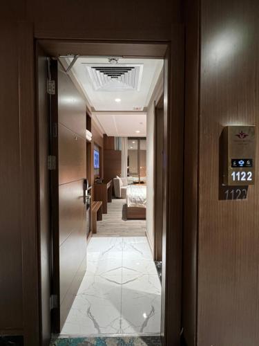 a hallway of a hotel with a door leading to a room at Violet Al Shisha Hotel in Makkah