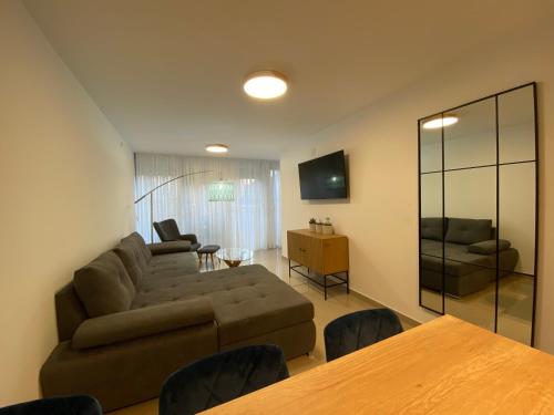 a living room with a couch and a table at Viridian Three Apartment, VALJEVO in Valjevo