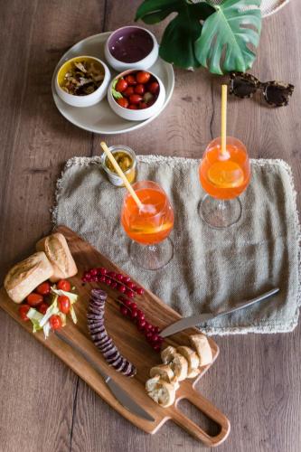 a wooden cutting board with food on a table at The Originals City, le Beaujoire, Nantes - FACE Parc Expo et FACE Stade Beaujoire in Nantes