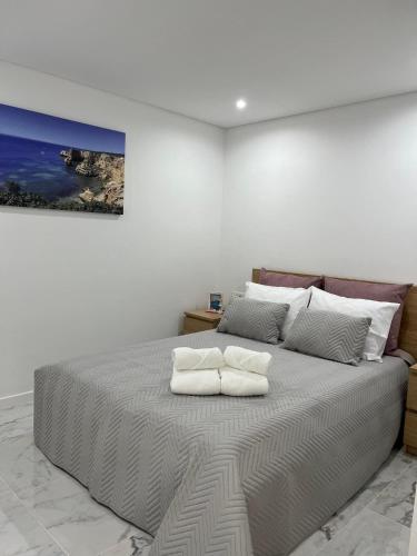 a bedroom with a bed with two pillows on it at Flat in Olhão city center in Olhão