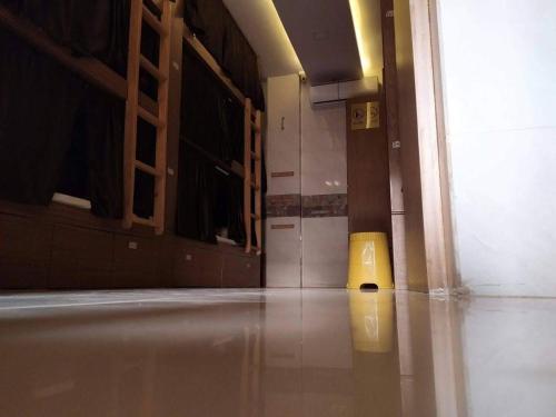 an empty room with a door and a yellow object on the floor at Super Champions Hostel in Mumbai