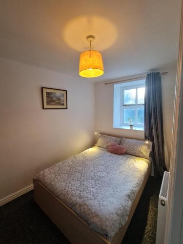 a small bedroom with a bed and a window at 3 bedroom apartment in Ulverston Cumbria in Ulverston