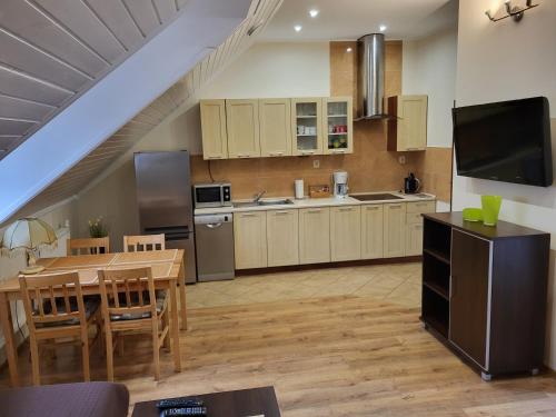 a kitchen with a table and a dining room at Apartament Fregata in Kołobrzeg