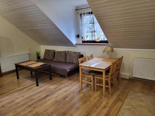 a living room with a couch and a table at Apartament Fregata in Kołobrzeg