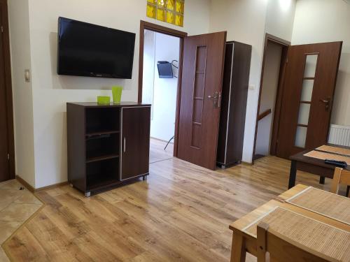 a living room with a flat screen tv on a wall at Apartament Fregata in Kołobrzeg