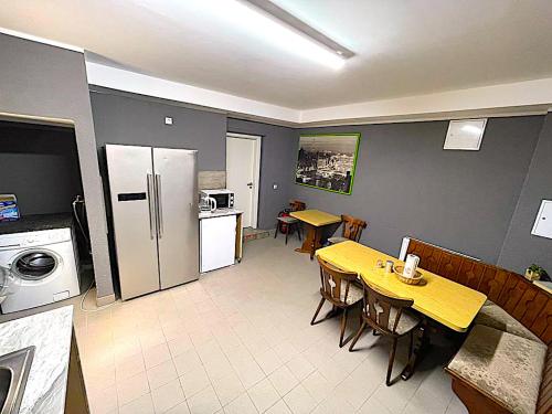 a kitchen and dining room with a table and a refrigerator at Hotel Uthoff in Bissendorf