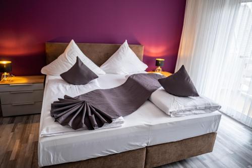 a bed with pillows on it in a bedroom at Mike‘s Mosel Lodge in Treis-Karden