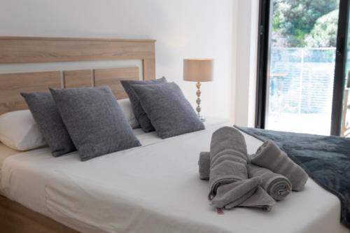 a bedroom with a bed with towels on it at Brand New Luxury 1 Bed 2 Bath Apartment - SPA, Pool & Gym in Gibraltar