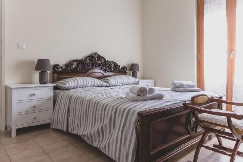 a bedroom with a large bed with towels on it at Casa Nanni - Pesaro in Pesaro