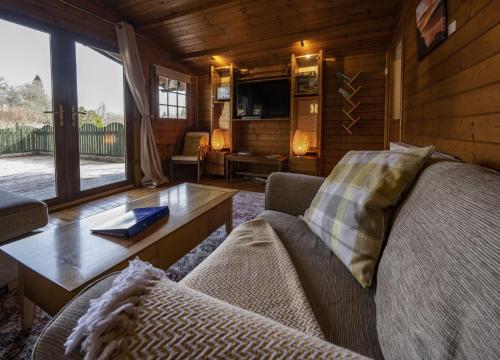 a living room with a couch and a table at Taigh Nan Daraich in Spean Bridge