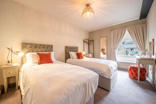 a bedroom with two beds and a window at Woodroffe Arms, Hope Room 2 in Hope