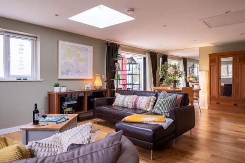 a living room with a couch and a table at The Nest in Brockenhurst
