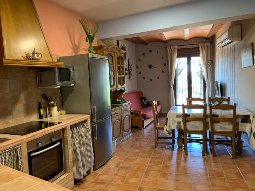 a kitchen with a table and a dining room at CASA JESUS in Abiego