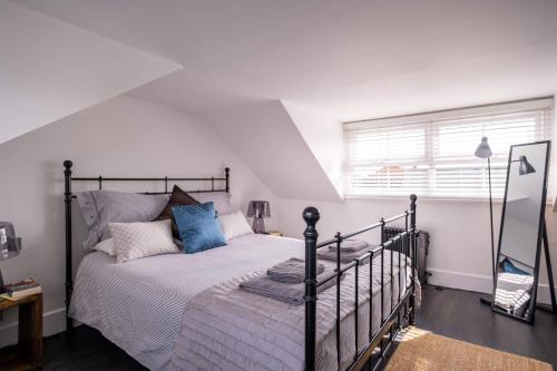 a bedroom with a bed and a window at Captain's Keep in Lymington