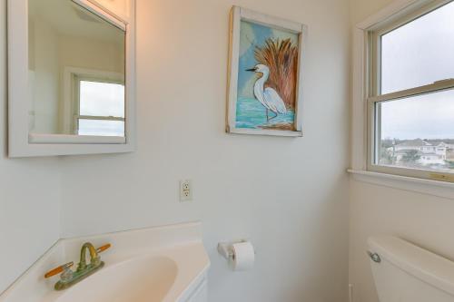 a bathroom with a white sink and two windows at Bayfront Cape May Vacation Rental with Beach Access in Cape May Court House