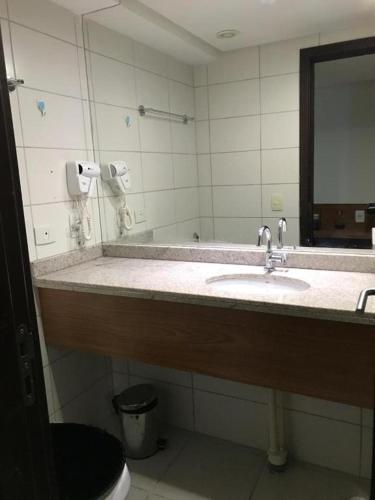 a bathroom with a sink and a mirror at BEACH CLASS EXECUTIVE apto 206 in Recife