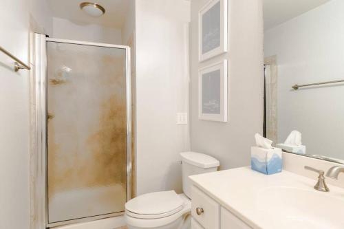 a bathroom with a shower and a toilet and a sink at Seascape 315 - Oceanfront Condo Overlooking Pool in Isle of Palms