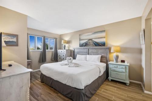a bedroom with a large bed and two windows at The Summit 307 in Panama City Beach