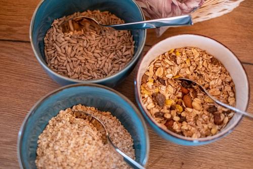 four bowls of oats and nuts on a table at Mike‘s Mosel Lodge in Treis-Karden