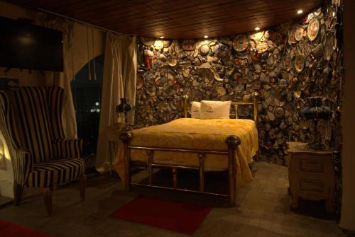 a bedroom with a bed and a wall with plates at Hotel Temático Casa Puebla in Puebla