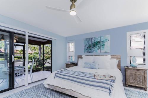 a bedroom with a bed with a blue wall at Yellow Pine Duplex Close to Pool & Tennis in Sarasota