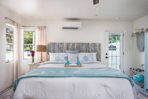 a bedroom with a large bed with blue pillows at Pelican Gardens Studio 3 on Lido Key in Sarasota