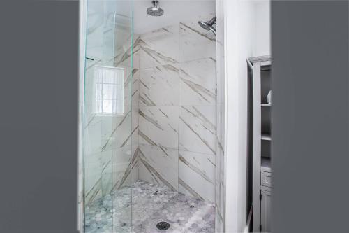 a bathroom with a shower with a glass wall at Pelican Gardens 7 By Lido Beach in Sarasota