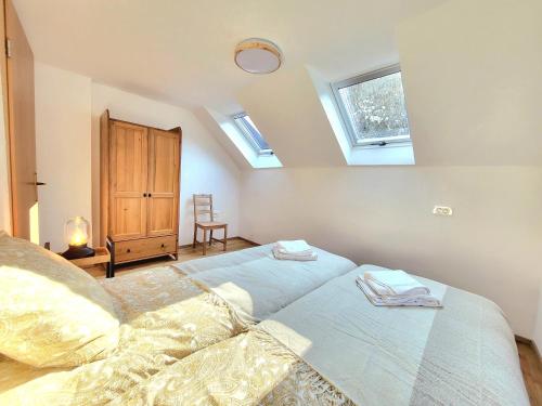 a bedroom with a bed with two towels on it at Bella Bela Apartments 23 in Bled