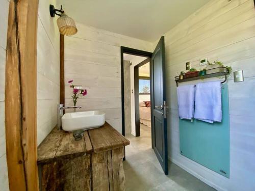 a bathroom with a sink on a wooden table at Cabaña con chimenea en Pto Varas in Puerto Varas