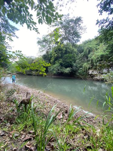 a person is standing next to a river at A Piece of Paradise in San Carlos