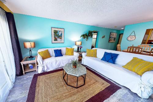 a living room with a white couch and a table at Kingston Arms On Lido Key, 1BR in Sarasota