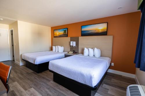 a room with two beds in a hotel room at Days Inn by Wyndham Monterey Downtown in Monterey
