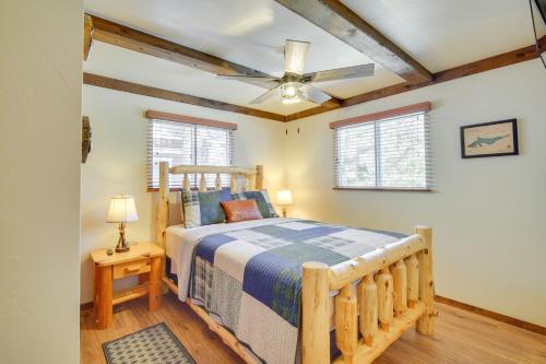 een slaapkamer met een houten bed en een plafondventilator bij Big Bear Cabin Near Lake, Snow Summit, and Bear Mtn! in Big Bear Lake