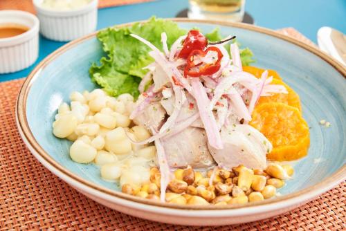 a bowl of food with meat and vegetables on a table at Libre Hotel, BW Signature Collection by Best Western in Lima