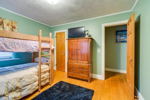 a bedroom with a bunk bed and a tv at Sodus Point Vacation Rental Steps to Lake Ontario in Sodus