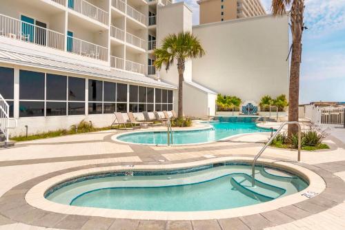 a swimming pool in front of a building at Best Western on the Beach in Gulf Shores
