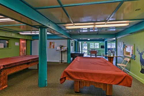 a room with two beds and a table in it at Pine Mountain Club Home with Beautiful View! in Frazier Park