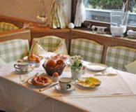 a table with plates of food on it at Hotel Bachmair Alpina in Rottach-Egern