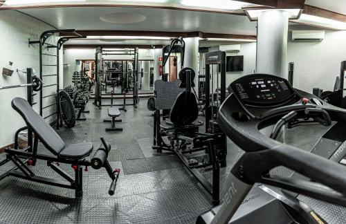 a gym with several treadmills and machines in it at Best Western Shalimar Praia Hotel in Porto Seguro