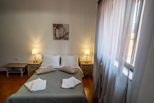 a bedroom with two beds and a window at Sea & Mountain Serenity in Plátsa