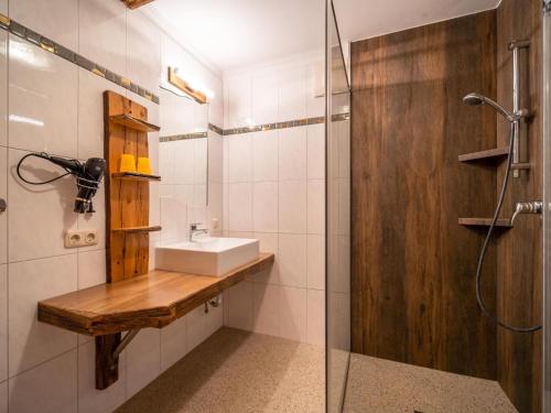 a bathroom with a sink and a shower at Sommerstein in Maria Alm am Steinernen Meer